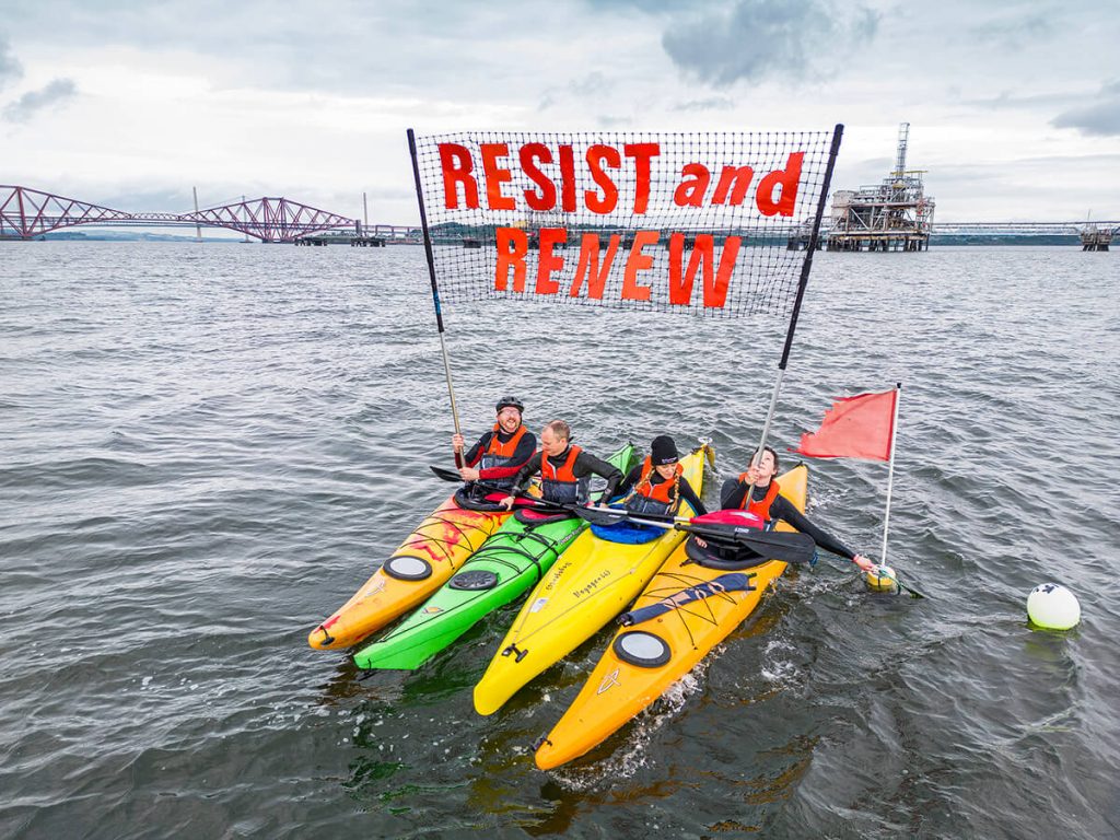 Kayakers hold-up Stop Rosebank banner in front of Forth Bridge and Hound Point Terminal