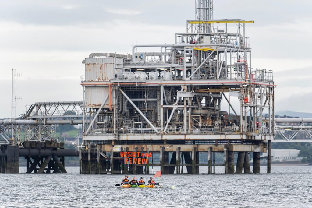 Kayakers hold-up Stop Rosebank banner in front of Forth Bridge and Hound Point Terminal